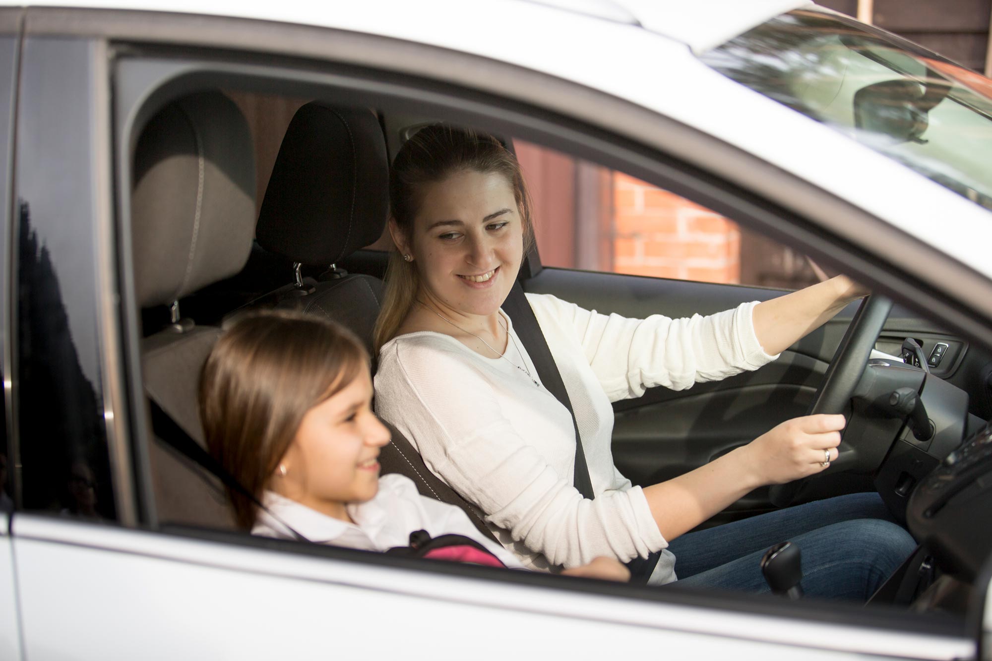 mother driving her daughter in car
